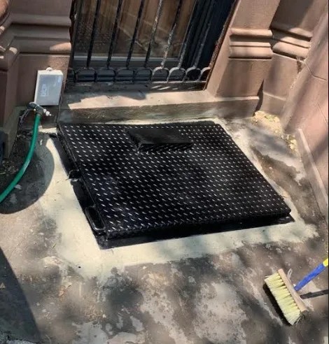 Steel Masters NYC crew installing a custom rolldown gate in a Brooklyn commercial building